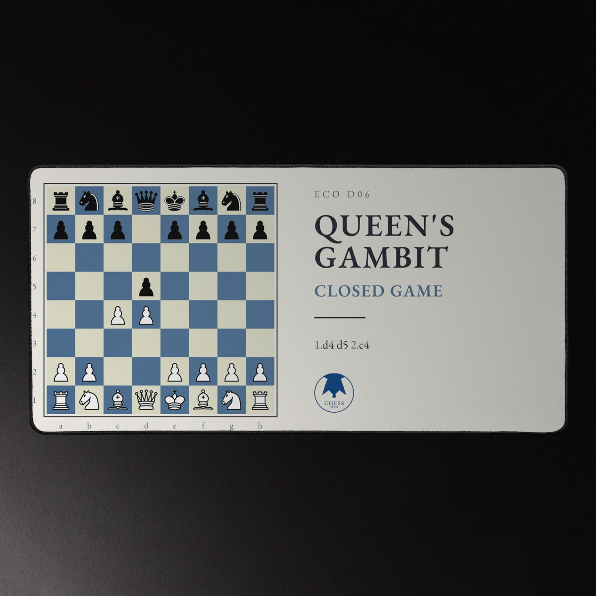 Queen's Gambit Chess Desk Mat on a desk with keyboard and headphones
